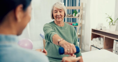 elderly woman holding up weights