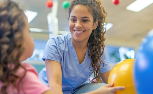 smiling OTA with young patient